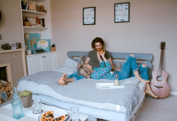 man and woman lying on bed together 