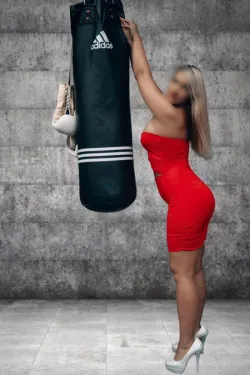 Ilona standing in a red dress while boxing